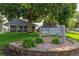 Lake Arbor Community Center sign surrounded by lush green landscaping and large mature trees at 8780 Chase Dr # 40, Arvada, CO 80003