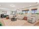Finished basement with neutral colors, plush seating, and multiple windows offering plenty of natural light at 2550 Gold Creek Dr, Elizabeth, CO 80107