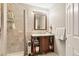 Bathroom featuring a tiled shower and wood vanity with storage at 2550 Gold Creek Dr, Elizabeth, CO 80107