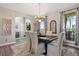 Elegant dining room with stylish chandelier, large windows, and neutral decor at 2550 Gold Creek Dr, Elizabeth, CO 80107