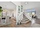 Inviting foyer with hardwood floors, staircase, and views into the dining and living areas at 2550 Gold Creek Dr, Elizabeth, CO 80107