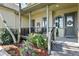 Charming covered front porch with seating, beautiful landscaping, and a welcoming entrance at 2550 Gold Creek Dr, Elizabeth, CO 80107