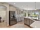 Bright kitchen features stainless steel appliances, gray cabinets and an island with white countertops at 2550 Gold Creek Dr, Elizabeth, CO 80107