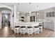 Bright kitchen with white cabinets, center island with seating, and modern appliances at 2550 Gold Creek Dr, Elizabeth, CO 80107