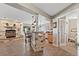 Open concept living room with stone fireplace and breakfast bar seating at kitchen counter at 2550 Gold Creek Dr, Elizabeth, CO 80107