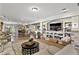 Spacious living room with stone fireplace, built-ins, and open layout to kitchen at 2550 Gold Creek Dr, Elizabeth, CO 80107