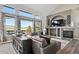 Comfortable living room featuring a fireplace, TV, and large windows with scenic views at 2550 Gold Creek Dr, Elizabeth, CO 80107