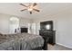 Comfortable main bedroom with a large bed, dresser, and a mounted television for relaxed viewing at 2550 Gold Creek Dr, Elizabeth, CO 80107