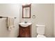Powder room featuring a wood vanity and a neutral color scheme at 2550 Gold Creek Dr, Elizabeth, CO 80107