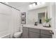 Bathroom featuring a shower-tub combo with modern fixtures, stylish vanity, and ample lighting at 2907 Distant Rock Ave, Castle Rock, CO 80109