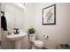 Modern powder room featuring a pedestal sink, sleek black fixtures, and stylish decor at 2907 Distant Rock Ave, Castle Rock, CO 80109