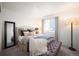 Comfortable bedroom with soft lighting, plush bedding, and a window view at 2907 Distant Rock Ave, Castle Rock, CO 80109