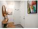Bright entryway featuring a wooden console table, artwork, and light-colored walls leading into the home at 2907 Distant Rock Ave, Castle Rock, CO 80109