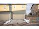 Attached two-car garage featuring an ample driveway, an exterior with warm, neutral colors and a well-kept lawn at 2907 Distant Rock Ave, Castle Rock, CO 80109