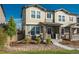 Inviting two-story townhome featuring stone accents, a cozy front porch, and manicured landscaping at 2907 Distant Rock Ave, Castle Rock, CO 80109
