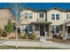 Charming two-story townhome with stone accents, inviting front porch, and well-manicured landscaping at 2907 Distant Rock Ave, Castle Rock, CO 80109