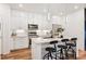 Bright kitchen with white cabinetry, stainless steel appliances, and a quartz countertop island with bar stool seating at 2907 Distant Rock Ave, Castle Rock, CO 80109