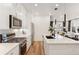 Sleek kitchen with stainless steel appliances, a gas range, white cabinetry, and a view into the living room at 2907 Distant Rock Ave, Castle Rock, CO 80109