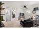 Bright living area with neutral carpet, ceiling fan, comfortable seating, and view into a home office at 2907 Distant Rock Ave, Castle Rock, CO 80109