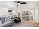 Inviting living room with modern decor, stylish seating, ceiling fan, and decorative shelving at 2907 Distant Rock Ave, Castle Rock, CO 80109