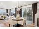 Living room and dining area featuring hardwood floors, contemporary furnishings, and expansive sliding glass doors to the outside at 2907 Distant Rock Ave, Castle Rock, CO 80109