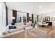 Bright, open living room with hardwood floors, lots of natural light, and modern decor at 2907 Distant Rock Ave, Castle Rock, CO 80109