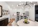 Open living space featuring eat-in kitchen with island, stainless steel appliances, and hardwood floors at 2907 Distant Rock Ave, Castle Rock, CO 80109
