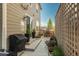 Cozy patio with a grill, seating area, privacy fence, and lush greenery at 2907 Distant Rock Ave, Castle Rock, CO 80109