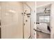 Modern bathroom featuring a tiled shower with glass door and a peek into the bedroom at 147 Silver Rock Trl, Castle Rock, CO 80104
