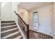 Bright entryway featuring hardwood floors, staircase, and direct access to the upper level at 147 Silver Rock Trl, Castle Rock, CO 80104