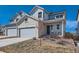 Charming two-story home with a two-car garage and inviting front porch with rocking chairs at 147 Silver Rock Trl, Castle Rock, CO 80104