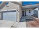 Inviting front porch with rocking chairs on a charming two-story home at 147 Silver Rock Trl, Castle Rock, CO 80104