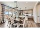 Open concept living with a dining area featuring a large sliding door and modern kitchen with stainless appliances at 147 Silver Rock Trl, Castle Rock, CO 80104