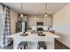 Modern kitchen featuring a large island with pendant lighting, stainless steel appliances, and gray cabinetry at 147 Silver Rock Trl, Castle Rock, CO 80104