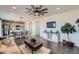 Open-concept living room featuring hardwood floors, stylish decor, and an adjoining dining area at 147 Silver Rock Trl, Castle Rock, CO 80104