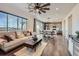 Bright open-concept living room with hardwood floors, modern decor, and seamless flow to the dining area at 147 Silver Rock Trl, Castle Rock, CO 80104