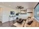 Comfortable living room with modern ceiling fan, stylish decor, and hardwood flooring at 147 Silver Rock Trl, Castle Rock, CO 80104