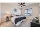 Comfortable main bedroom with a ceiling fan, plush carpet, and a window with blinds at 147 Silver Rock Trl, Castle Rock, CO 80104