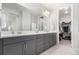 Spacious main bathroom with double vanity, modern fixtures, and a walk-in closet at 10524 Eby Cir, Lone Tree, CO 80124