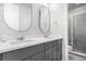 Bathroom featuring dual sinks, dark cabinets, and modern fixtures at 10524 Eby Cir, Lone Tree, CO 80124