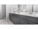 Well-lit main bathroom with double vanity, modern fixtures, and ample counter space at 10524 Eby Cir, Lone Tree, CO 80124