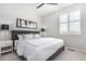 Well-lit bedroom with ceiling fan, neutral colors, and a bright window at 10524 Eby Cir, Lone Tree, CO 80124