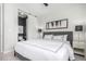 Light and airy bedroom featuring a glimpse into the ensuite bathroom with modern sliding door at 10524 Eby Cir, Lone Tree, CO 80124