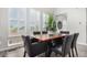 Bright dining area featuring multiple windows with white shutters, a wooden table, and a decorative floral centerpiece at 10524 Eby Cir, Lone Tree, CO 80124