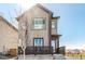 Modern two-story home with neutral siding, a small front porch, and a well-manicured lawn at 10524 Eby Cir, Lone Tree, CO 80124