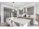 Modern kitchen featuring gray cabinets, stainless steel appliances, a large island, and pendant lighting at 10524 Eby Cir, Lone Tree, CO 80124
