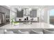 Contemporary kitchen featuring gray cabinets, stainless steel appliances, a large island, and modern pendant lighting at 10524 Eby Cir, Lone Tree, CO 80124