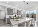 Charming modern kitchen with gray cabinets, a large island, stainless steel appliances, and outdoor access at 10524 Eby Cir, Lone Tree, CO 80124