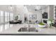 Modern, open-concept kitchen featuring stainless steel appliances and a spacious island overlooking the living area at 10524 Eby Cir, Lone Tree, CO 80124