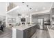 Open-concept kitchen, living room, and dining area featuring an island, modern appliances, fireplace, and a balcony at 10524 Eby Cir, Lone Tree, CO 80124
